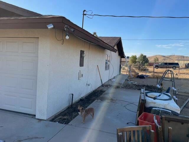 view of side of property with a mountain view and a garage