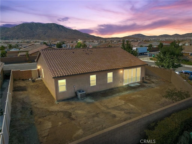 exterior space with a mountain view and central AC