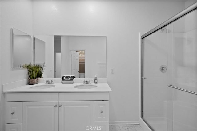 bathroom with vanity and a shower with door