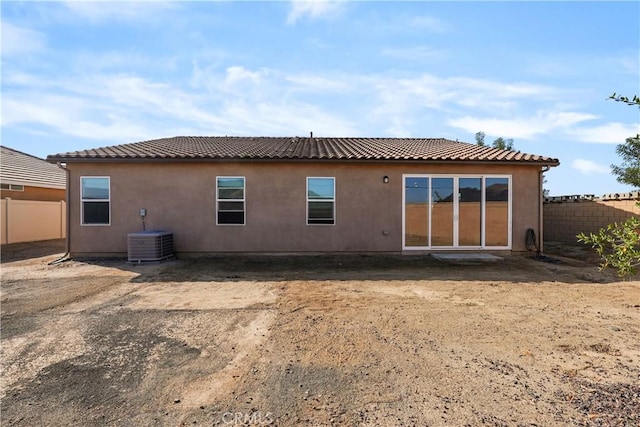 rear view of property featuring central AC