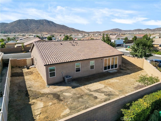 back of house featuring a mountain view and cooling unit