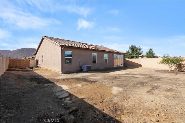 rear view of house featuring a mountain view and cooling unit