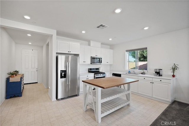 kitchen featuring white cabinetry, appliances with stainless steel finishes, and sink