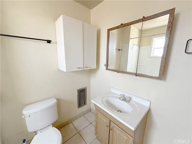 bathroom with vanity, toilet, and tile patterned floors