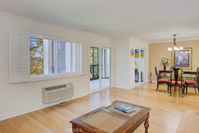 living room with crown molding, light hardwood / wood-style floors, and a wall unit AC