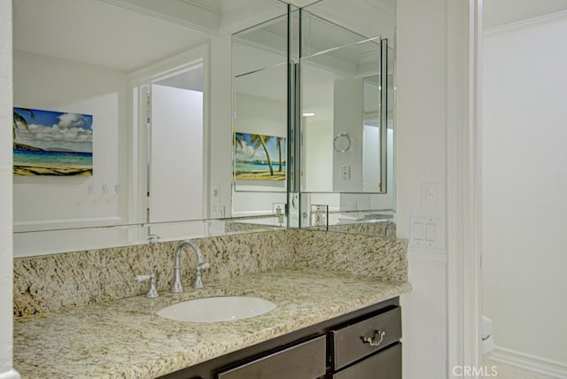 bathroom with crown molding and vanity