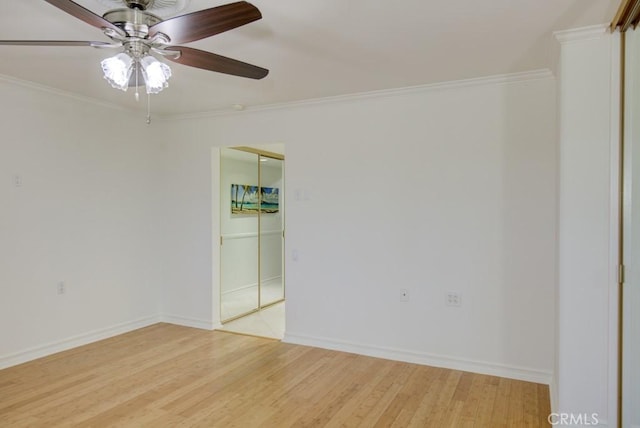 empty room with crown molding, hardwood / wood-style flooring, and ceiling fan