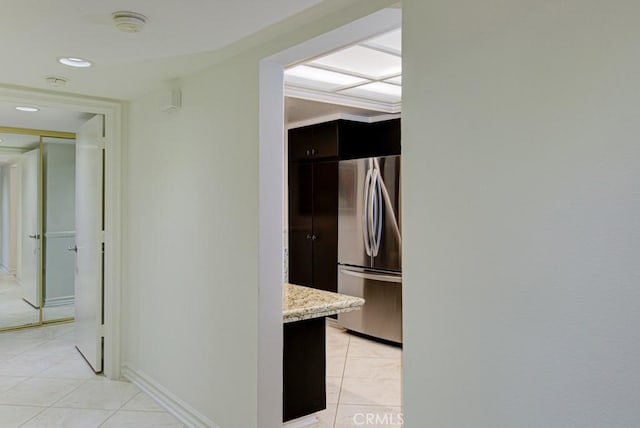 hall featuring light tile patterned floors