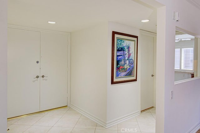 hall with light tile patterned floors