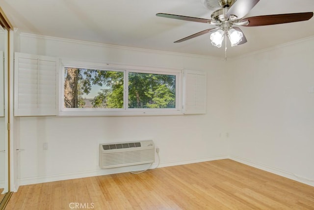 spare room with light wood-type flooring, ceiling fan, a wall mounted AC, and ornamental molding