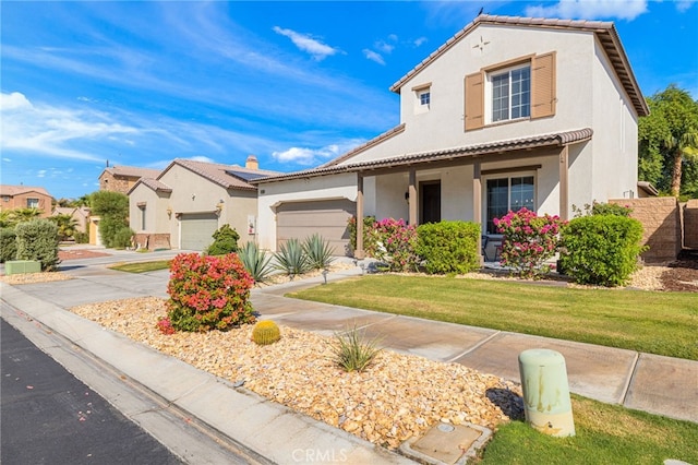 mediterranean / spanish house with a front yard and a garage