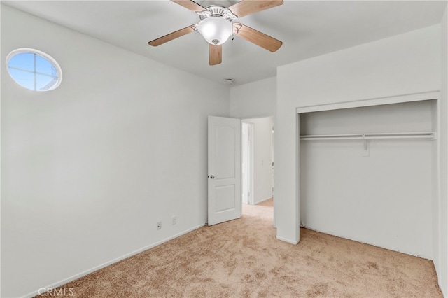 unfurnished bedroom with ceiling fan, a closet, and light carpet