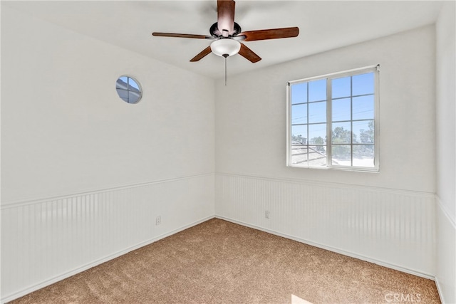 spare room featuring ceiling fan and light colored carpet