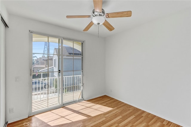 spare room featuring hardwood / wood-style flooring and ceiling fan