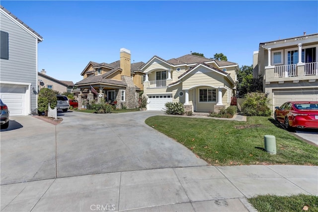 view of front of property with a front lawn, a balcony, and a garage