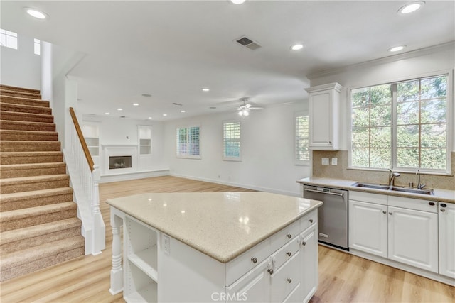 kitchen featuring light hardwood / wood-style flooring, sink, white cabinets, and dishwasher