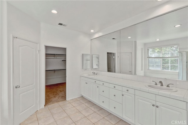 bathroom featuring tile patterned flooring and vanity