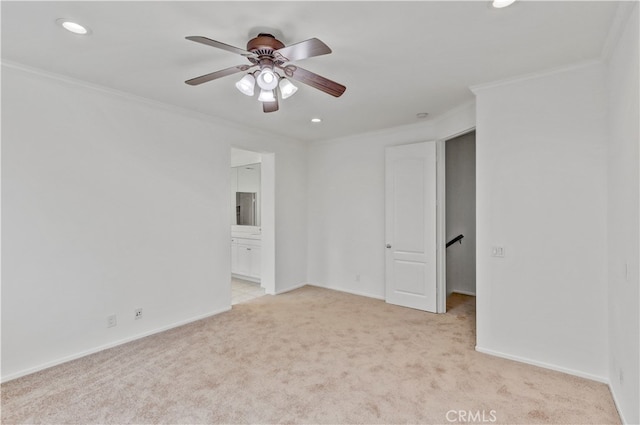 unfurnished room featuring ornamental molding, light carpet, and ceiling fan