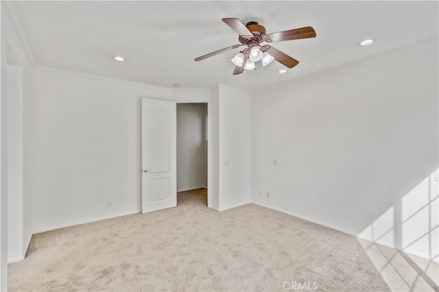 carpeted empty room featuring ceiling fan and ornamental molding