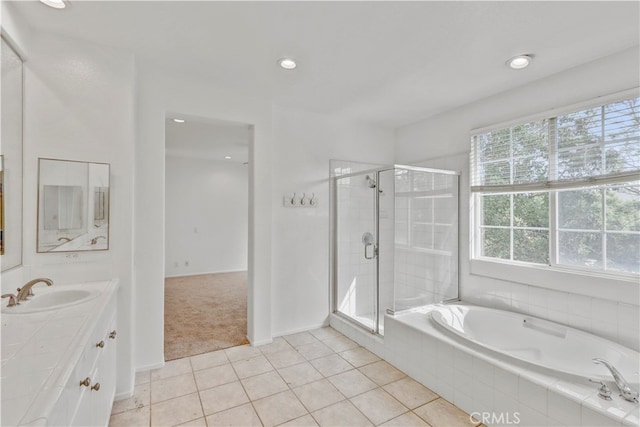 bathroom featuring tile patterned flooring, separate shower and tub, and vanity