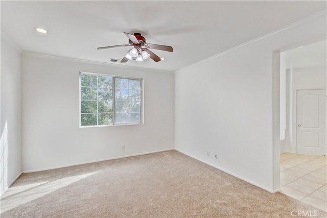 spare room featuring ornamental molding, ceiling fan, and light colored carpet