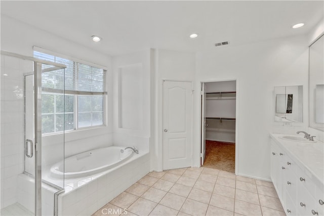 bathroom with tile patterned flooring, vanity, and shower with separate bathtub