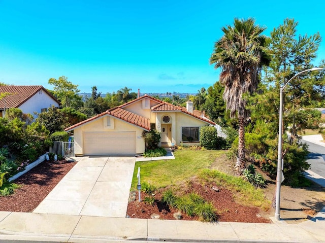 mediterranean / spanish-style home with a front yard and a garage