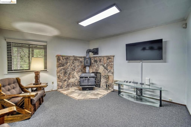 living room with ornamental molding, carpet flooring, and a wood stove