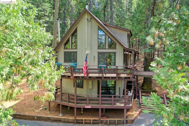 back of house featuring a wooden deck