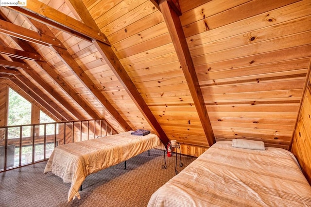 bedroom with lofted ceiling with beams, carpet, wood walls, and wooden ceiling