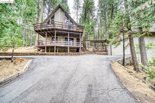 view of front of house featuring a garage and a wooden deck