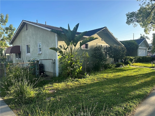 view of property exterior with a lawn