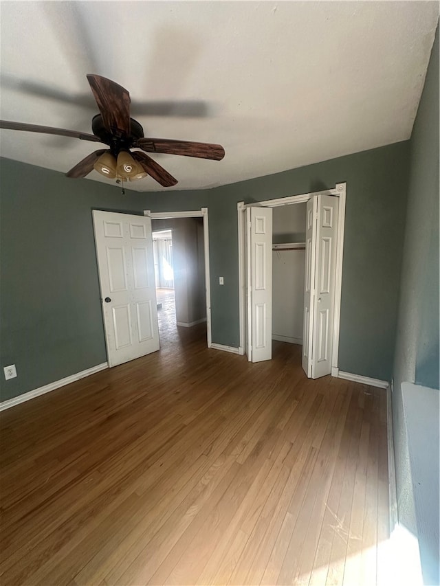 unfurnished bedroom with hardwood / wood-style floors and ceiling fan