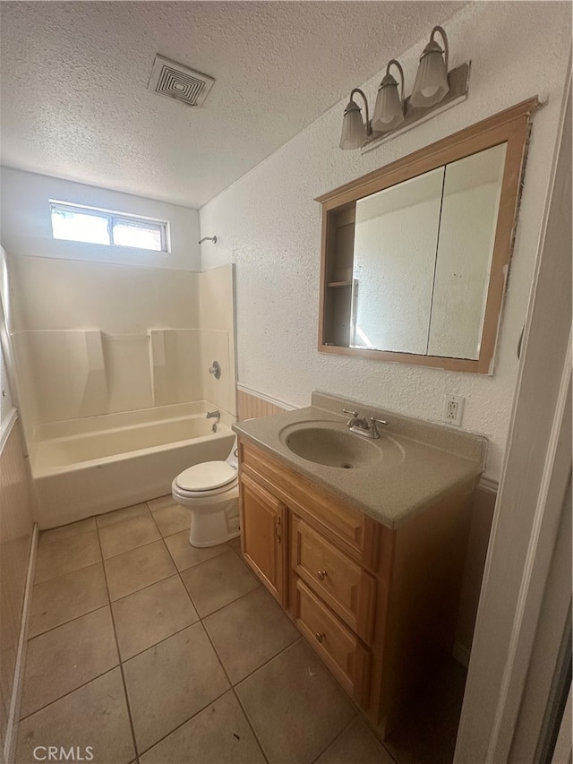 full bathroom featuring vanity, a textured ceiling, tile patterned flooring, shower / tub combination, and toilet