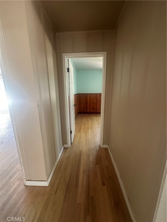 hallway with light hardwood / wood-style floors