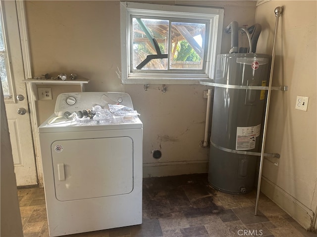 clothes washing area featuring washer / clothes dryer and water heater