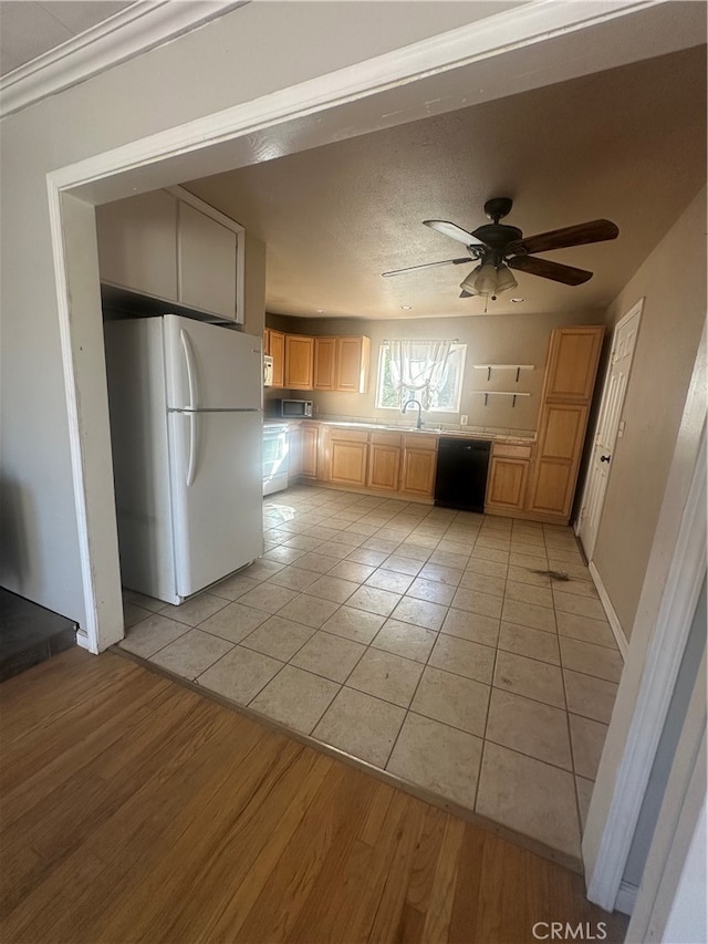 kitchen with black dishwasher, white fridge, light hardwood / wood-style flooring, light brown cabinets, and ceiling fan