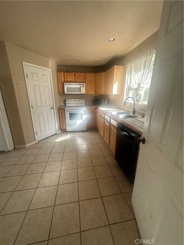 kitchen featuring white appliances, light tile patterned flooring, and sink