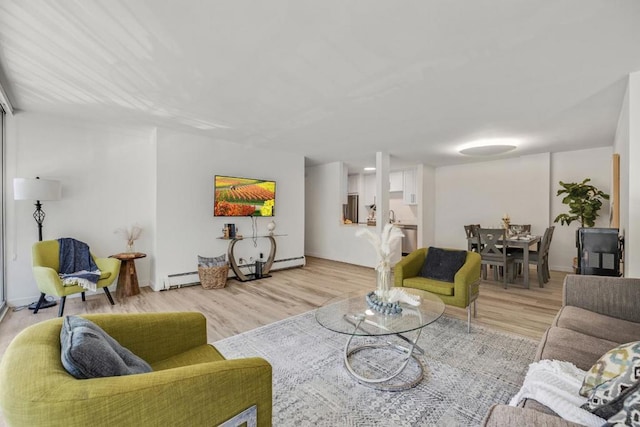 living room with light hardwood / wood-style floors and a baseboard radiator