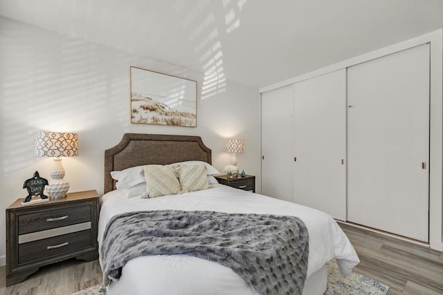 bedroom with a closet and light hardwood / wood-style flooring