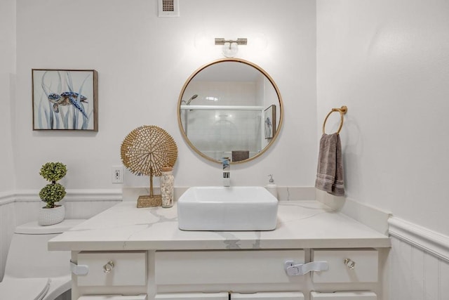 bathroom with a shower, toilet, and vanity