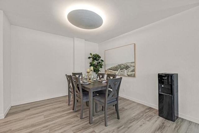 dining space with light hardwood / wood-style floors