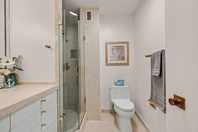 bathroom featuring toilet, tile patterned floors, walk in shower, and vanity