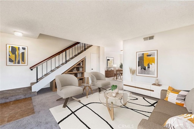 living room featuring light carpet and a textured ceiling