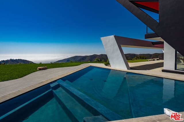 view of swimming pool with a mountain view