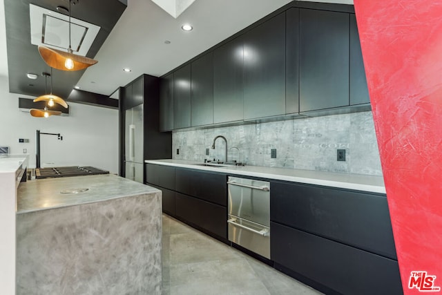 kitchen with decorative backsplash, sink, and decorative light fixtures