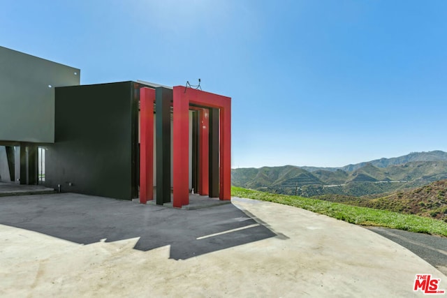 view of property with a mountain view and a carport