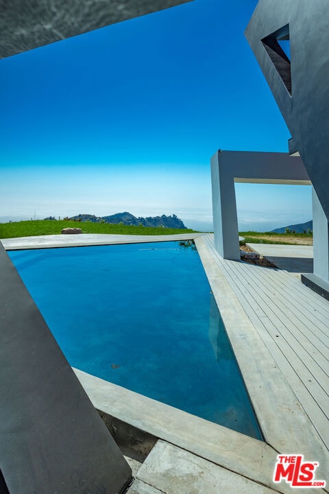 view of swimming pool with a deck