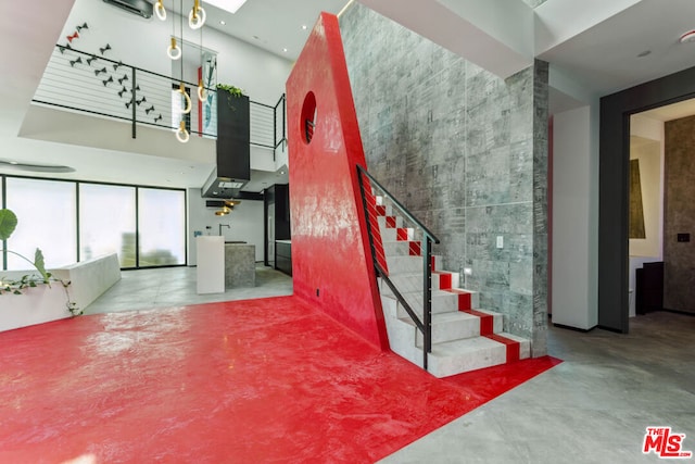 stairs with concrete flooring