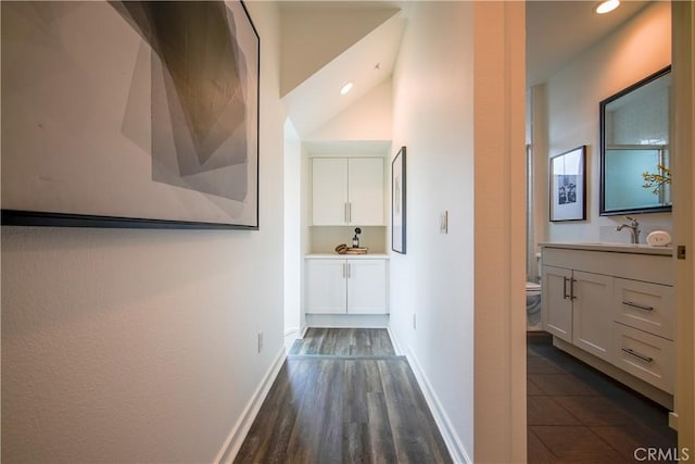 hallway with dark hardwood / wood-style floors and sink